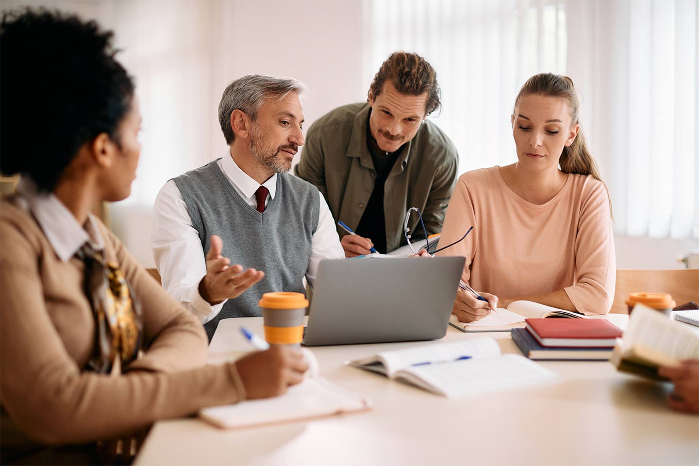 group of four people working together