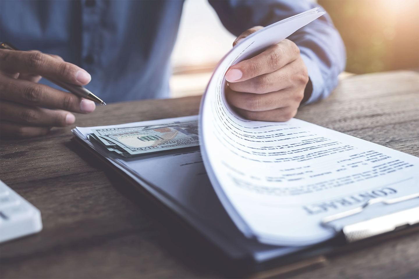 man signing documents