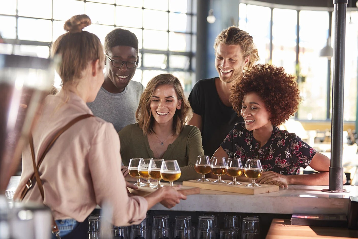 four people doing a beer tasting in a bar