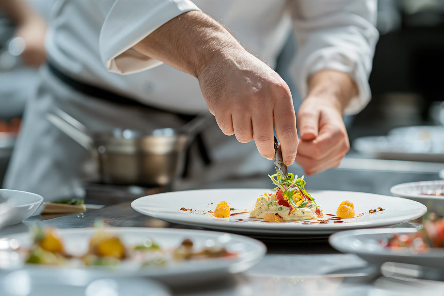 chef artfully prepares a plate